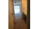 Inviting hallway leading to a carpeted bedroom and a quaint built-in vanity area at 512 W Venice Ave # 205, Venice, FL 34285