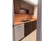 View of a kitchen with orange countertops and brown cabinets at 512 W Venice Ave # 205, Venice, FL 34285
