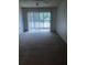 A vacant living room with sliding glass doors and a ceiling fan at 512 W Venice Ave # 205, Venice, FL 34285