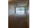 A vacant living room showing the sliding glass doors to the balcony at 512 W Venice Ave # 205, Venice, FL 34285