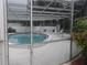 Enclosed community pool area with lounge chairs, offering a refreshing recreational space at 512 W Venice Ave # 205, Venice, FL 34285