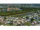 Aerial view showcases home in quiet neighborhood near community waterways and golf course at 552 Bellaire Dr, Venice, FL 34293