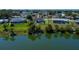 Aerial view showcasing a home with a screened-in pool, fenced yard, and waterfront location at 552 Bellaire Dr, Venice, FL 34293