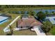 A full aerial view of a home with a fenced-in backyard and pool overlooking the lake at 552 Bellaire Dr, Venice, FL 34293