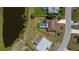 Aerial view of home with pool, screen enclosure, and lake view in a desirable neighborhood at 552 Bellaire Dr, Venice, FL 34293