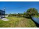 Large backyard features a black metal fence and glimpses of the lake at 552 Bellaire Dr, Venice, FL 34293