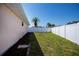 Backyard with green lawn, mulch and privacy fence at 552 Bellaire Dr, Venice, FL 34293