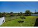 Expansive backyard boasts lush lawn and a black metal fence, offering beautiful views of nature at 552 Bellaire Dr, Venice, FL 34293
