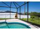 Fenced backyard with pool, grassy area, and mature landscaping at 552 Bellaire Dr, Venice, FL 34293
