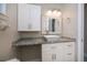 Bathroom vanity with granite countertop, vessel sink, white cabinets, and modern lighting at 552 Bellaire Dr, Venice, FL 34293
