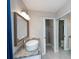 Bathroom features a modern vanity with granite countertop, vessel sink, and a frameless glass shower door at 552 Bellaire Dr, Venice, FL 34293