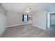 Bedroom with modern floors, ceiling fan, wainscotting, and access to ensuite bathroom at 552 Bellaire Dr, Venice, FL 34293
