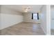 Bedroom with modern floors, ceiling fan, wainscotting, and window overlooking a yard at 552 Bellaire Dr, Venice, FL 34293