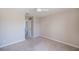 Cozy bedroom with plush carpeting, neutral walls, and a doorway leading to other rooms at 552 Bellaire Dr, Venice, FL 34293