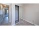 A bright bedroom with neutral carpet and a sliding mirror closet doors near the hall at 552 Bellaire Dr, Venice, FL 34293