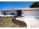 Charming single-story home featuring a well-manicured lawn and attached two car garage at 552 Bellaire Dr, Venice, FL 34293