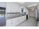 Bright kitchen with white cabinets, granite countertops, stainless appliances and tile floors with a pool view at 552 Bellaire Dr, Venice, FL 34293