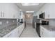 Modern kitchen featuring granite countertops, stainless steel appliances, and ample cabinet space at 552 Bellaire Dr, Venice, FL 34293