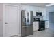 This kitchen showcases granite countertops, stainless steel appliances and bright white cabinetry and tile floors at 552 Bellaire Dr, Venice, FL 34293
