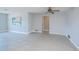 Open and airy living room with neutral paint, tile flooring and an open doorway at 552 Bellaire Dr, Venice, FL 34293