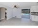 Open living area with tile floors, a ceiling fan and a sliding door leading to the pool area at 552 Bellaire Dr, Venice, FL 34293