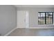 Bright living room featuring tile flooring, large window, and a fresh coat of neutral paint at 552 Bellaire Dr, Venice, FL 34293