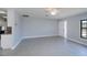 Spacious living room with tile floors, ceiling fan, and an open layout into the kitchen at 552 Bellaire Dr, Venice, FL 34293