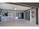 Covered outdoor patio with wood paneling, ceiling fan, and sliding glass doors to the living space and pool at 552 Bellaire Dr, Venice, FL 34293