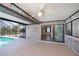 Screened in patio with 'Welcome' sign, ceiling fan, and access to the pool and backyard at 552 Bellaire Dr, Venice, FL 34293