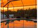 Inviting pool with an enclosure reflecting the brilliant colors of the sunset at 552 Bellaire Dr, Venice, FL 34293