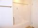 Bathroom featuring shower with tile surround and a safety grab bar at 554 Aspen Ave, Venice, FL 34285
