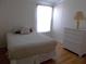 Cozy bedroom with a comfortable bed and natural light from the window at 554 Aspen Ave, Venice, FL 34285