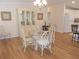 Inviting dining area with light-filled windows, hardwood floors, and a classic glass table at 554 Aspen Ave, Venice, FL 34285