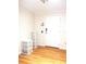 Neutral-toned entry featuring wood flooring and a white front door at 554 Aspen Ave, Venice, FL 34285