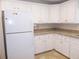 Bright kitchen featuring classic white cabinets, laminate countertops and tile flooring at 554 Aspen Ave, Venice, FL 34285