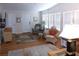 Bright living room featuring hardwood floors, white walls, and large windows with natural light at 554 Aspen Ave, Venice, FL 34285