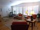 Bright living room featuring hardwood floors, white walls, and large windows with natural light at 554 Aspen Ave, Venice, FL 34285