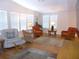 Bright living room featuring hardwood floors, white walls, and large windows with natural light at 554 Aspen Ave, Venice, FL 34285