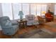 Bright living room featuring hardwood floors, white walls, and large windows with natural light at 554 Aspen Ave, Venice, FL 34285