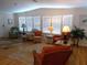 Bright living room featuring hardwood floors, white walls, and large windows with natural light at 554 Aspen Ave, Venice, FL 34285