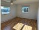 Bright bedroom with light wood-look floors and two windows at 56 Lakeview Dr, North Port, FL 34287