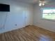 Bedroom with wood-look floors, ceiling fan and closet at 56 Lakeview Dr, North Port, FL 34287