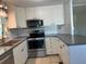 This kitchen includes white cabinets, stainless steel appliances, and ample counter space at 56 Lakeview Dr, North Port, FL 34287
