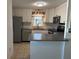 This kitchen has stainless steel appliances, white cabinets, and a window at 56 Lakeview Dr, North Port, FL 34287