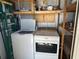 Efficient laundry space featuring a modern washer and dryer set with convenient overhead storage at 56 Lakeview Dr, North Port, FL 34287