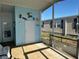 Outdoor porch area featuring a light blue wall with coastal decor and shade coverage at 56 Lakeview Dr, North Port, FL 34287