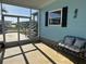Inviting front porch with comfortable bench seating, screen doors, and view of the community at 56 Lakeview Dr, North Port, FL 34287