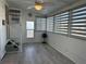 Bright sunroom with modern blinds, ceiling fan, and access to stairs, providing a relaxing and airy space at 56 Lakeview Dr, North Port, FL 34287