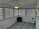 Relaxing sunroom featuring stylish window treatments, ceiling fan, and space for cozy furniture and decor at 56 Lakeview Dr, North Port, FL 34287