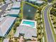Aerial view showcasing condominiums, a community pool, landscaping, lakes, and a fountain at 5739 Sabal Trace Dr # 102, North Port, FL 34287